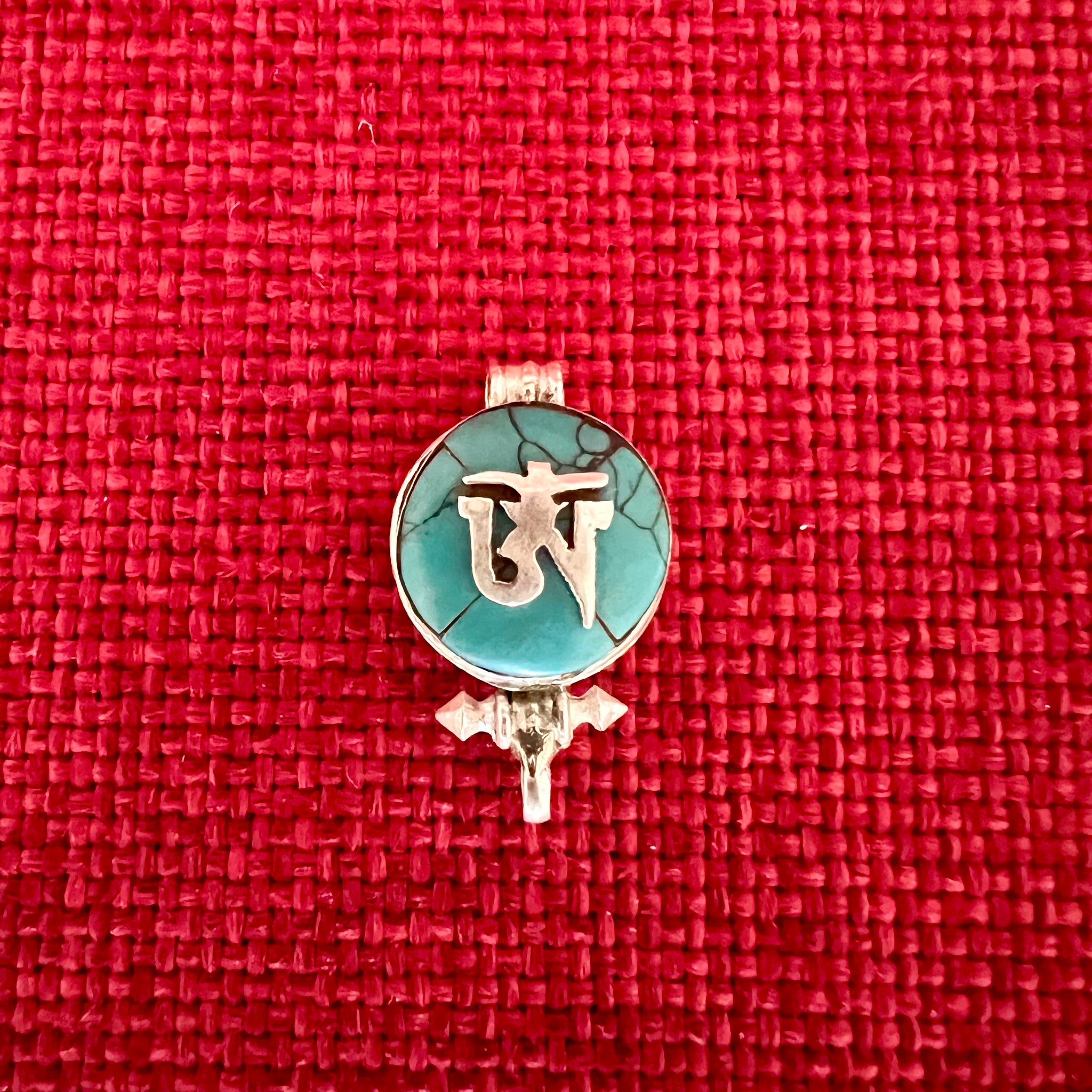 1.5cm diameter Sterling Silver Locket with the Tibetan Om symbol set on composite turquoise