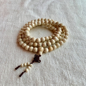 9mm Lotus Seed Mala with brown string and the Endless Knot Symbol
