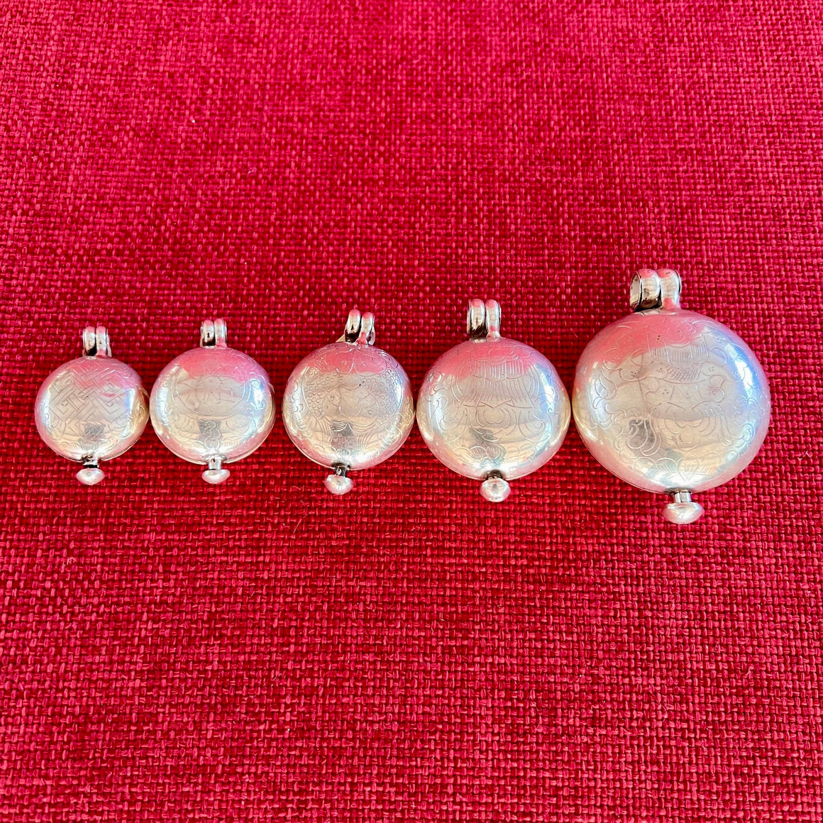 Round silver lockets with auspicious symbols in 5 sizes
