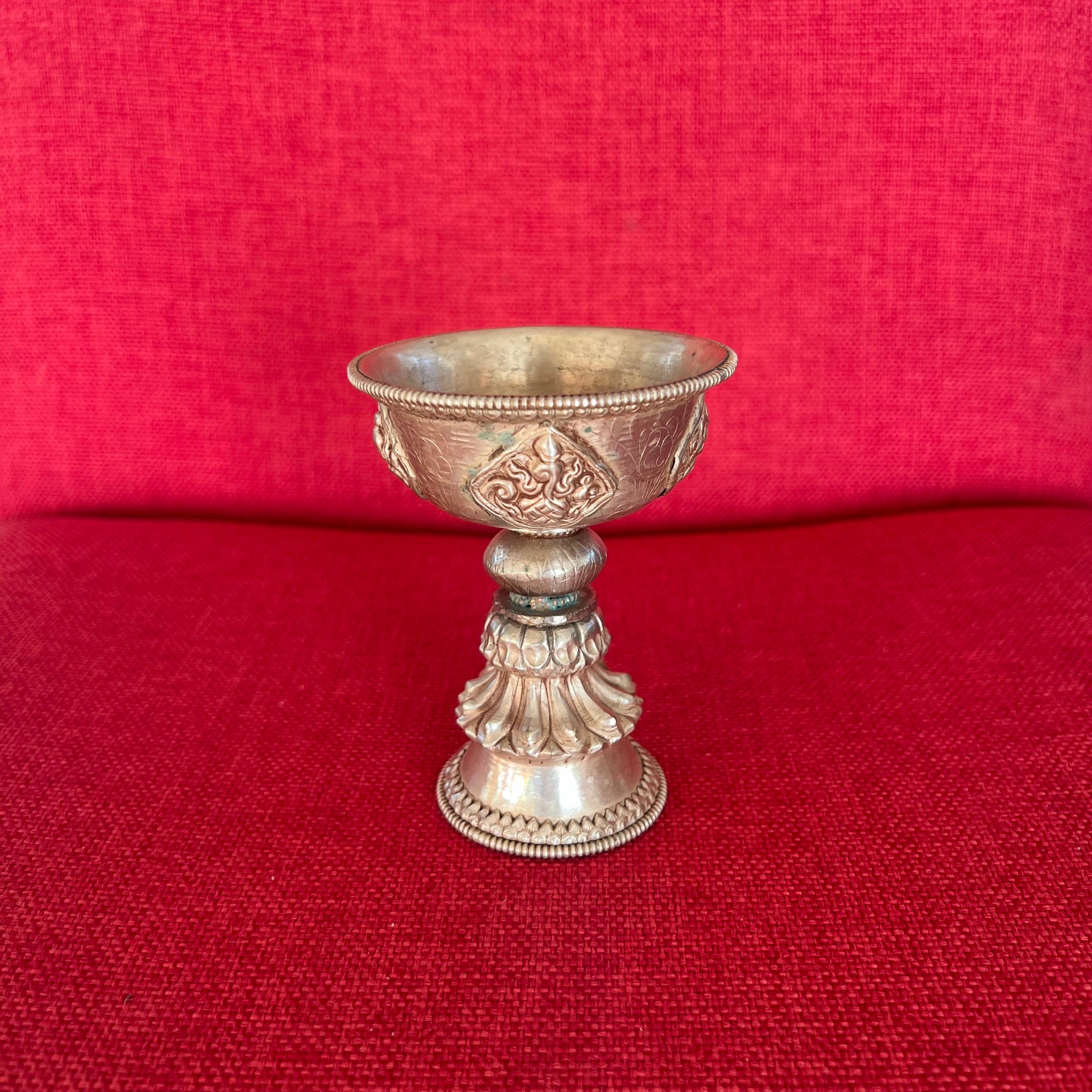 Silver Plated Butterlamp with Embossed Auspicious Symbols which is 10.5cm high and 8cm in diameter
