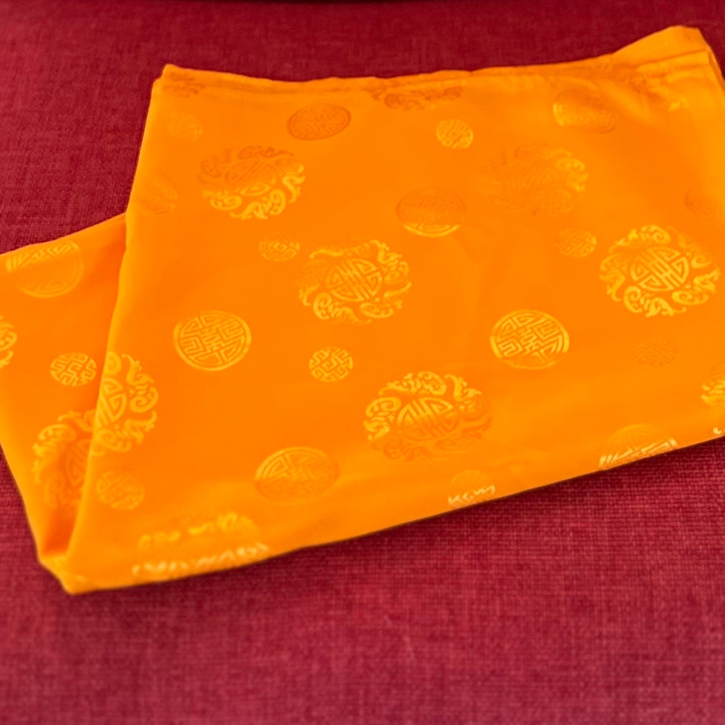 Dark yellow mandala offering cloth with Lucky Coin symbols