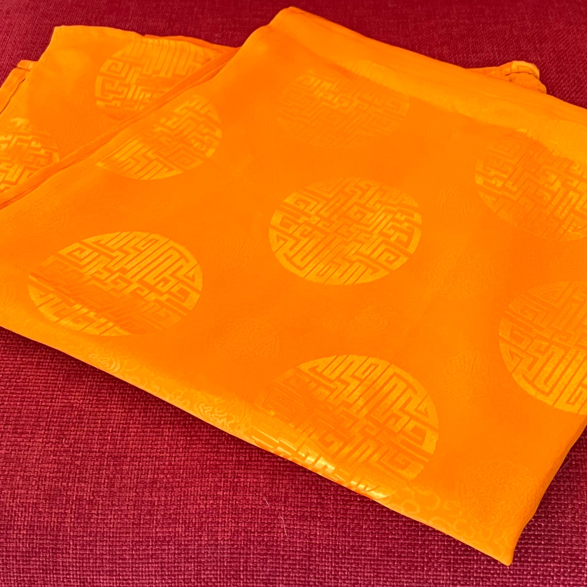 Dark yellow mandala offering cloth with Lucky Coin symbols