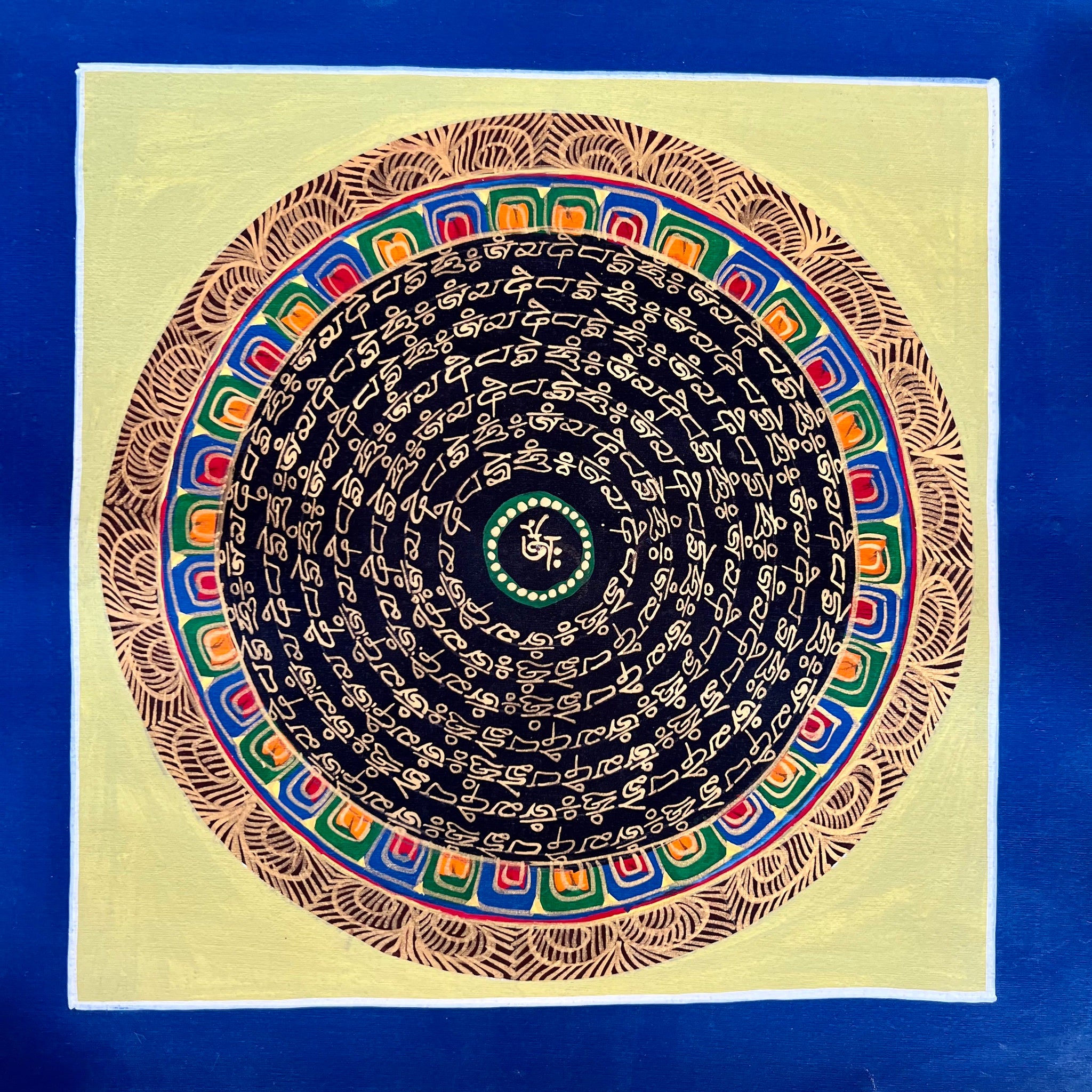 26.3cm Square Mandala Painting with the Tibetan Om symbol and the Om Mani Padme Hung Mantra painted in gold on black with a pale yellow background