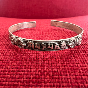 0.6cm wide flat shaped silver bangle with om mani padme hung mantra and dorje symbols