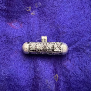 4cm long silver horizontal cylinder locket embossed with 8 auspicious symbols and dorje and scroll with Om Mani Padme Hung mantras inside