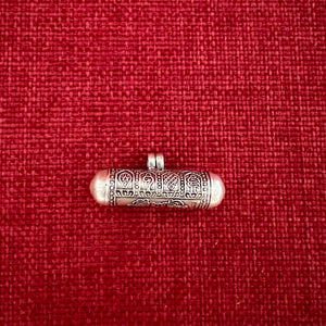 4cm long silver horizontal cylinder locket embossed with 8 auspicious symbols and dorje and scroll with Om Mani Padme Hung mantras inside