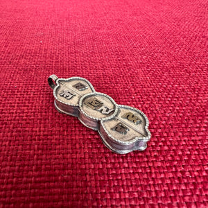 4.5cm silver locket in shape of dorje with om mani padme hung in sanskrit symbols empossed on front
