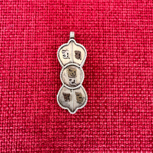 4.5cm silver locket in shape of dorje with om mani padme hung in sanskrit symbols empossed on front