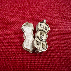 4.5cm silver locket in shape of dorje with om mani padme hung in sanskrit symbols empossed on front
