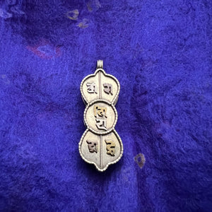 4.5cm silver locket in shape of dorje with om mani padme hung in sanskrit symbols empossed on front