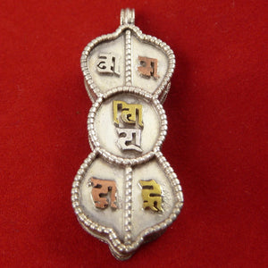 4.5cm silver locket in shape of dorje with om mani padme hung in sanskrit symbols empossed on front