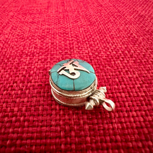 1.5cm diameter Sterling Silver Locket with the Tibetan Om symbol set on composite turquoise