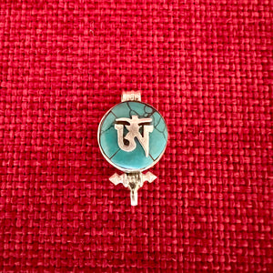 1.5cm diameter Sterling Silver Locket with the Tibetan Om symbol set on composite turquoise