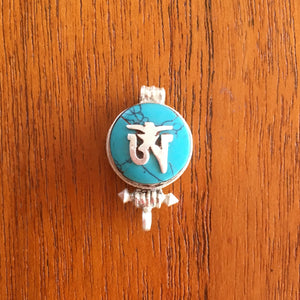 1.5cm diameter Sterling Silver Locket with the Tibetan Om symbol set on composite turquoise