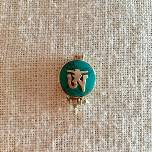 1.5cm diameter Sterling Silver Locket with the Tibetan Om symbol set on composite turquoise
