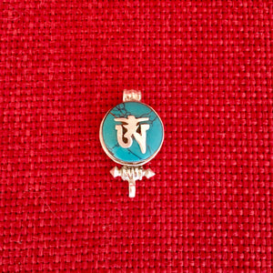 1.5cm diameter Sterling Silver Locket with the Tibetan Om symbol set on composite turquoise