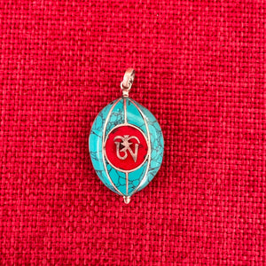 Coloured silver pendant with Tibetan OM symbol on one side and the Endless Knot symbol on the other side