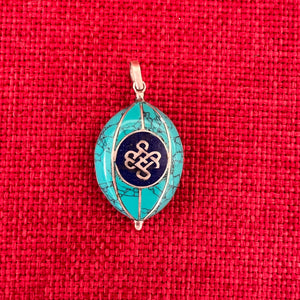 Coloured silver pendant with Tibetan OM symbol on one side and the Endless Knot symbol on the other side