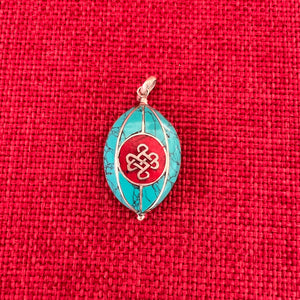 Coloured silver pendant with Tibetan OM symbol on one side and the Endless Knot symbol on the other side