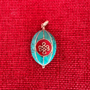 Coloured silver pendant with Tibetan OM symbol on one side and the Endless Knot symbol on the other side