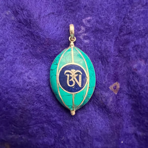 Coloured silver pendant with Tibetan OM symbol on one side and the Endless Knot symbol on the other side