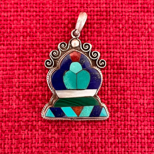 Silver and semi precious stone pendant in the shape of a Norbu
