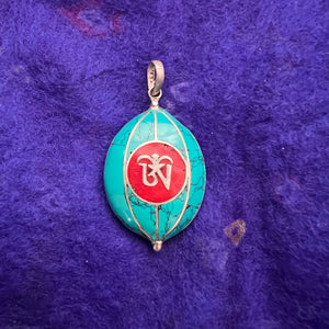 Coloured silver pendant with Tibetan OM symbol on one side and the Kalachakra symbol on the other side