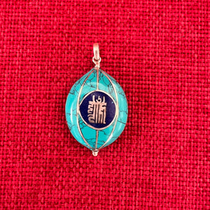 Coloured silver pendant with Tibetan OM symbol on one side and the Kalachakra symbol on the other side