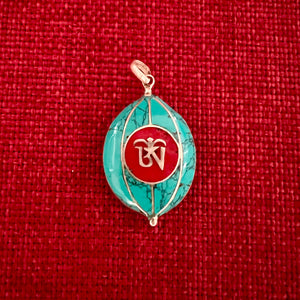 Coloured silver pendant with Tibetan OM symbol on one side and the Kalachakra symbol on the other side