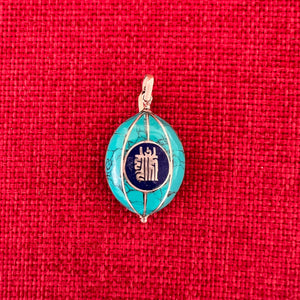 Coloured silver pendant with Kalachakra symbol on one side and the Endless Knot symbol on the other side