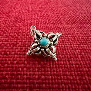 2cm silver '9 point' double dorje pendant with turquoise and coral detail
