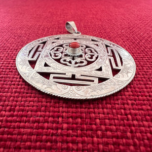 5cm diameter intricate silver buddhist mandala pendant with coral in centre
