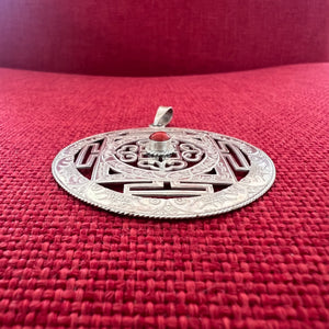 5cm diameter intricate silver buddhist mandala pendant with coral in centre