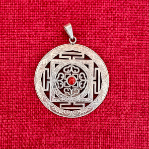 5cm diameter intricate silver buddhist mandala pendant with coral in centre