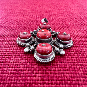 4cm sterling silver pendant with large coral stones in the symbolic shape of a Double Dorje
