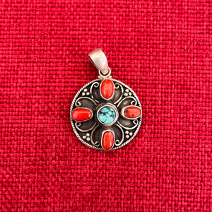 3cm round sterling silver pendant with turquoise and coral stones in the symbolic shape of a Double Dorje