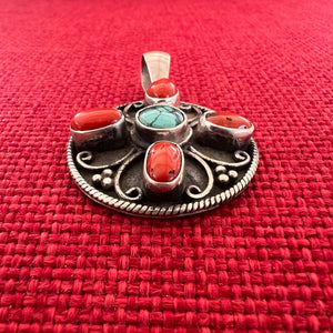3cm round sterling silver pendant with turquoise and coral stones in the symbolic shape of a Double Dorje