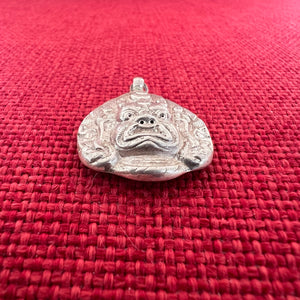 Silver pendant depicting a Buddhist Wrathful deities face