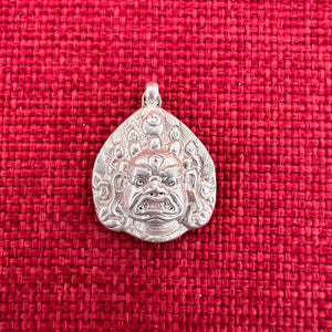 Silver pendant depicting a Buddhist Wrathful deities face